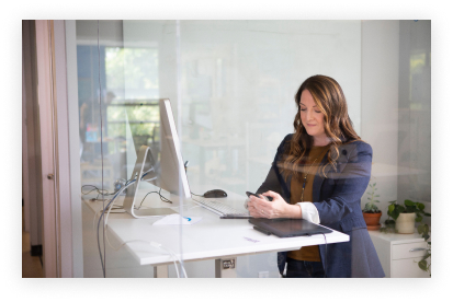 A person in front of a PC at a desk