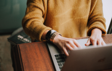 A person in front of a laptop at a desk