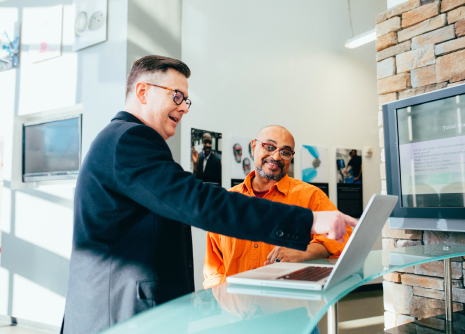 Two people looking at a laptop